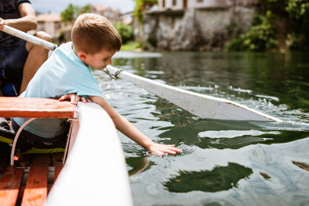 istock Young boy enjoying boat ride 1328221111