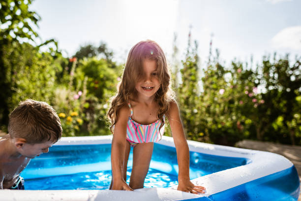 istock Children games in swimming pool 1328221742