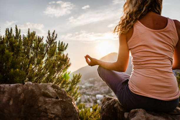istock Young woman preforms yoga in mountains at sunset 1328221864