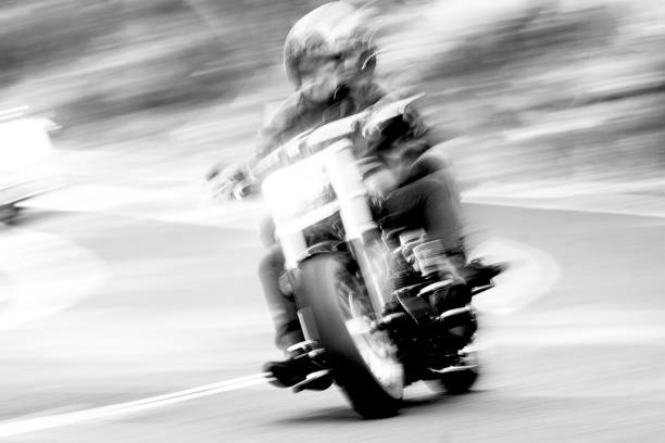 istock Black and white Speeding motorcycle on highway, blurred motion, background with copy space 1328224682