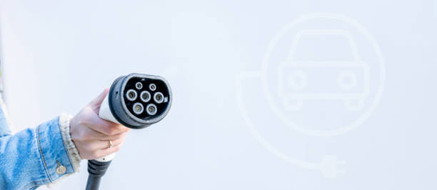 Electric car charging station. Power cable pump plug in recharge fuel technology with cable to power battery. Eco green energy hybrid vehicle on future charger station. EV fuel Plug in hybrid car estación de carga de coches eléctricos. enchufe de la bomba del cable de alimentación en la tecnología de recarga de combustible con cable para alimentar la batería. vehículo híbrido de energía verde eco en la futura estación de cargador. combusti