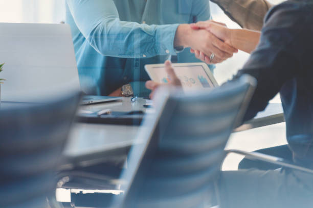 istock Close up of two Businessmen shaking hands. 1328226445