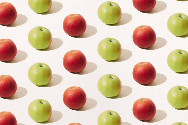 istock Red and green apple on a light beige background. Minimal summer scene and pattern. 1328230242