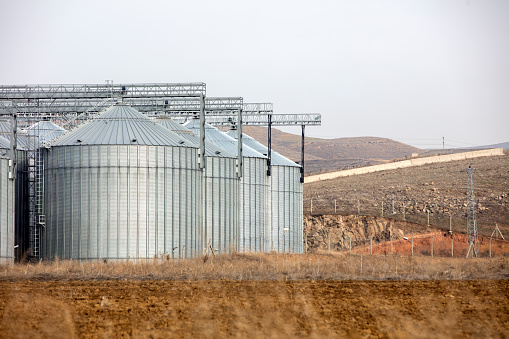 Agricultural silver silo on field