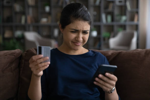 istock Close up unhappy Indian woman having problem with credit card 1328237090