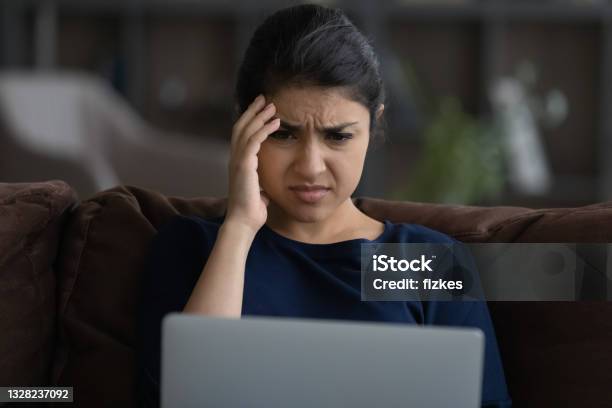 Close Up Unhappy Indian Woman Looking At Laptop Screen Stock Photo - Download Image Now