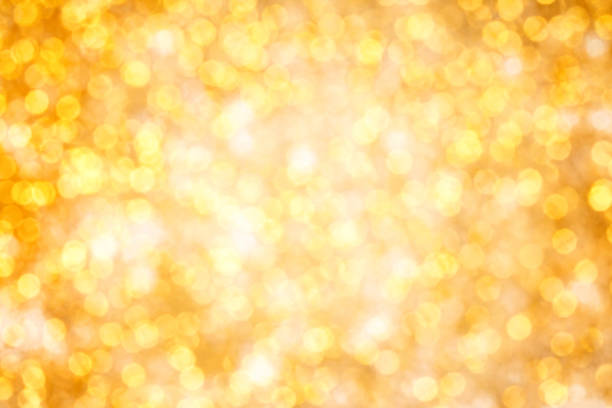 istock Golden bokeh pattern. Abstract background blurred beautiful shiny gold lights Christmas. Bright twinkle lights festive. 1328237442