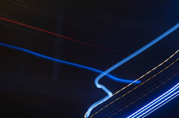 istock Multicolored light traces against dark background. Chaotic lines 1328238238