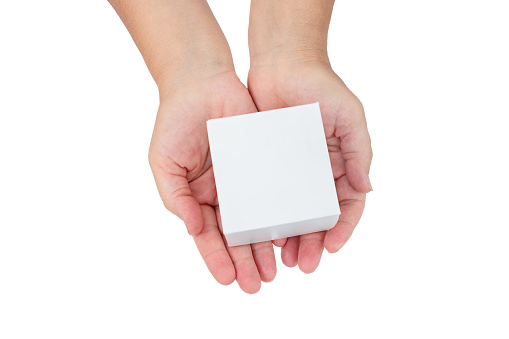 Female hands hold white cardboard box isolated on white background