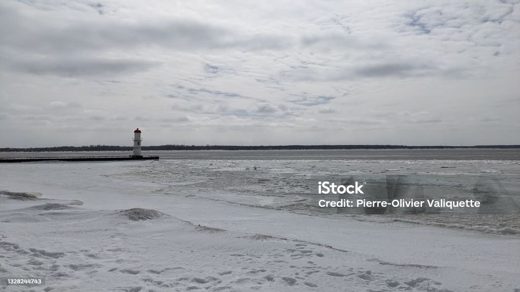 Snow-covered Shore of the Quai du Phare de Lachine (ph2) View of the wharf and the former Lachine lighthouse in Montreal, Quebec from the shore. 2021 Stock Photo