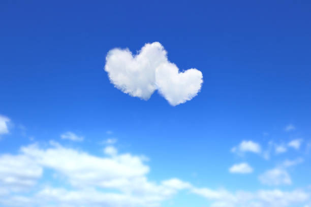 istock Two heart-shaped clouds in the blue sky. 1328247549