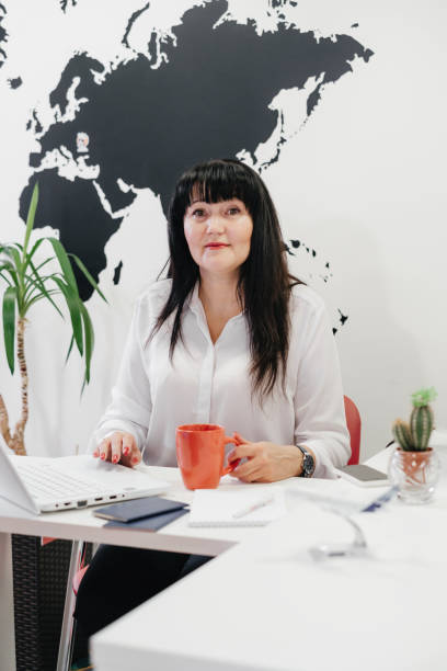 istock Confident travel agent using laptop in office for communication on-line 1328254624