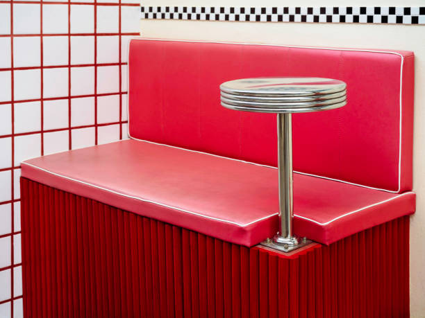 istock Empty round stainless steel side table fixing on red retro style diner booths. 1328255517