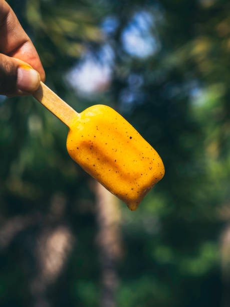 Woman with yellow popsicle.
