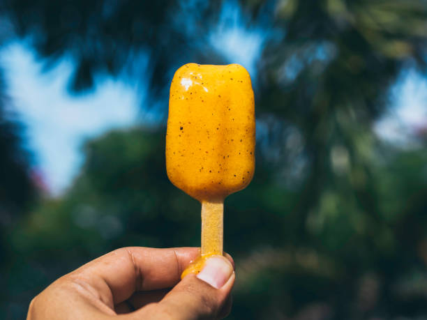 Woman with yellow popsicle.