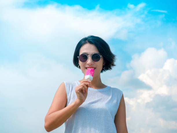 istock Woman with pink popsicle. 1328255566