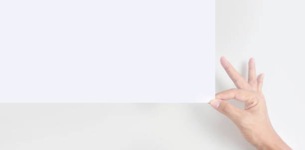 istock Empty space for text.Hand is holding the white blank paper 1328262652