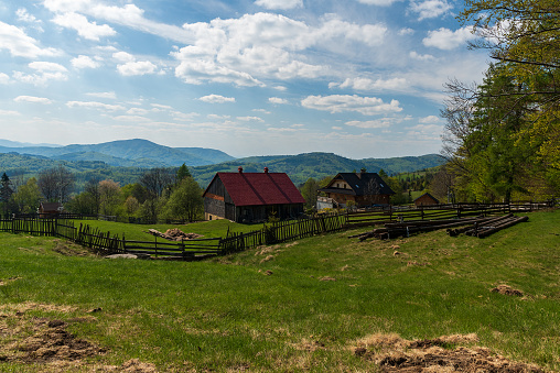 Beautiful Grabowa settlement with few wooden houses and hills on the background above Brenna village in Beskid Slaski mountains in Poland