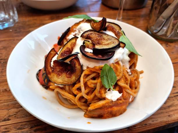 Spaghetti with tomato sauce, mozzarella, basil and eggplant