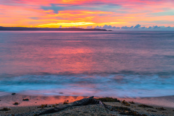 istock Cloud covered sunrise seascape tinged with pink 1328274841