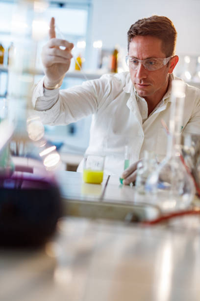 istock Mid adult chemist analyzing medical sample in laboratory. 1328274950