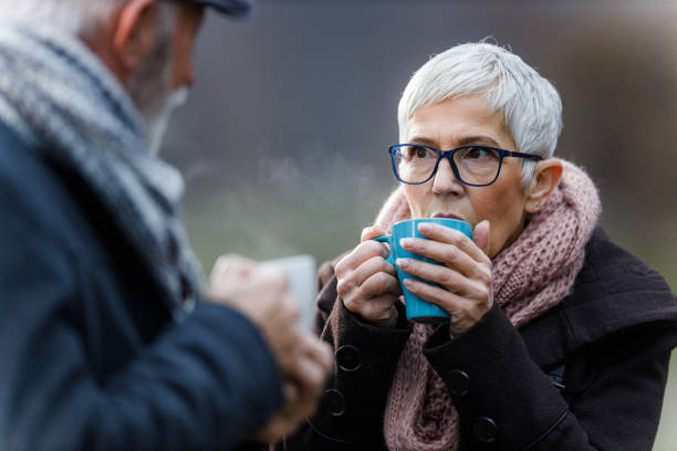 istock Senior couple drinking hot drink in nature. 1328275914