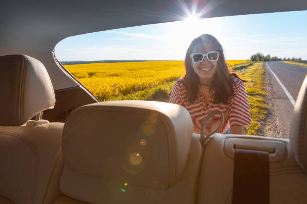 istock view from car trunk smiling woman at road side 1328276560