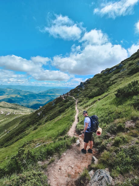 istock young hiker man in mountains. summer trekking path 1328276568