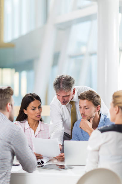istock Entrepreneurs reading business reports in the office. 1328276804