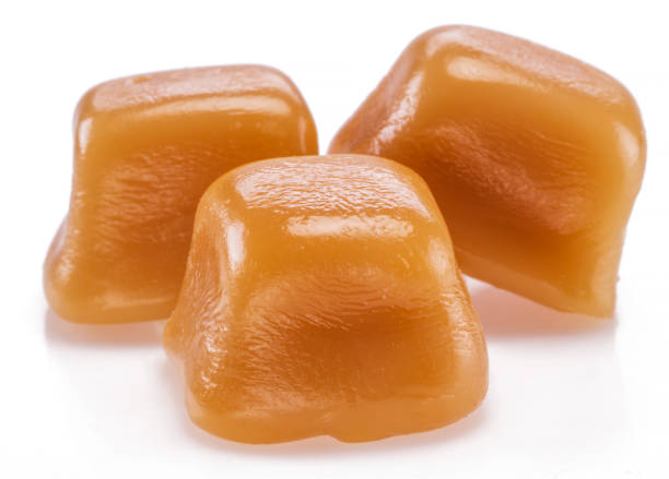 istock Toffee or candy caramel sweets isolated on white background. 1328277987