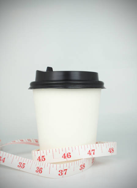 Pouring cream over a coffee on white background