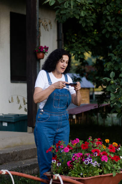 istock Modern mature woman using smart phone 1328280760