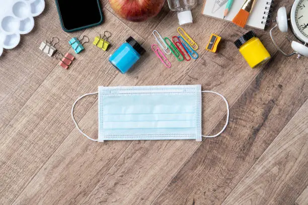 Photo of Back to school design concept with stationery over wooden table background.