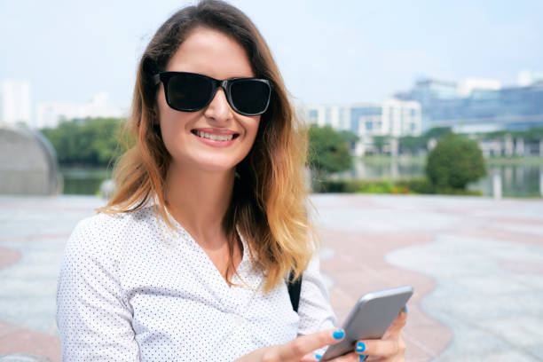 istock Texting Smiling Businesswoman 1328281609