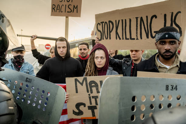 istock Protesting people with signs at street 1328281711