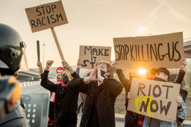 istock Activists holding signs at rally in protest 1328281840