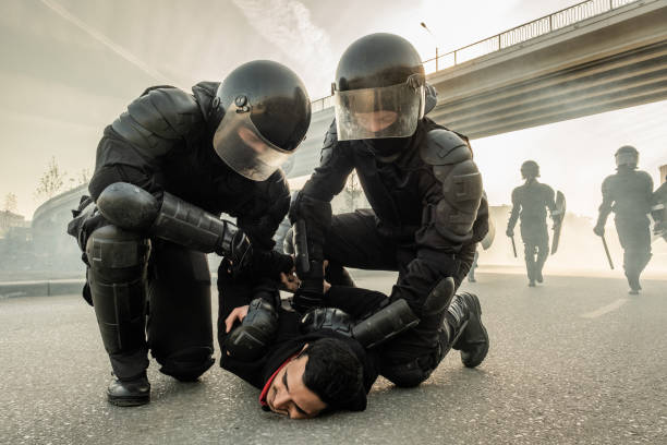 istock Arresting protester on street 1328282185
