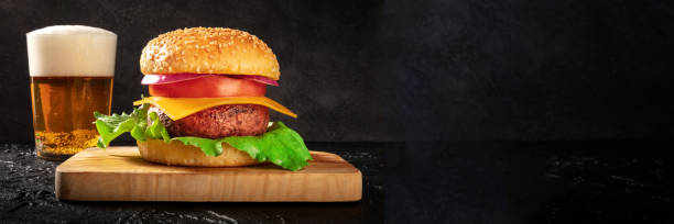 istock Beer and burger panorama with copy space. Restaurant banner with a hamburger 1328284553