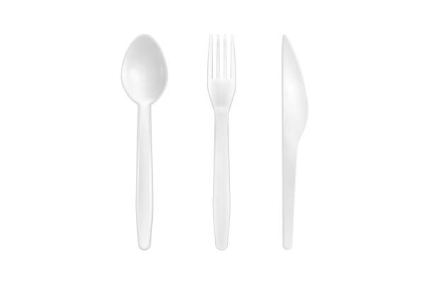istock White plastic spoon, fork and knife isolated on white background. Close up of disposable tableware. 1328286071