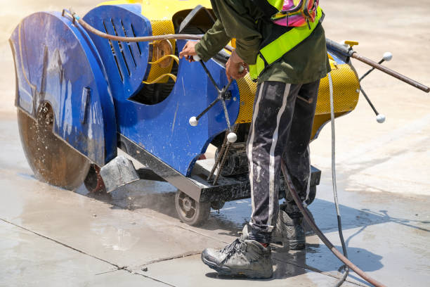 istock Worker contorl cutting machine are cutting concrete expansion and isolation joint pavement renovation work at construction factory building. 1328286284