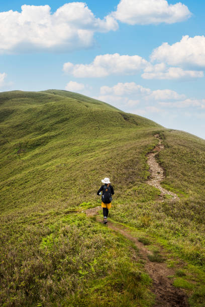 istock A lone hiker makes her way up to a mountain summit 1328287551