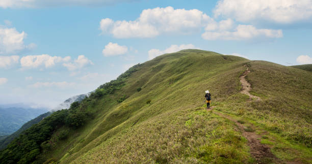 istock A lone hiker makes her way up to a mountain summit 1328287558