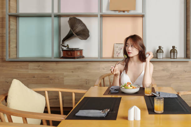 istock Woman Eating Lunch at Restaurant 1328288120