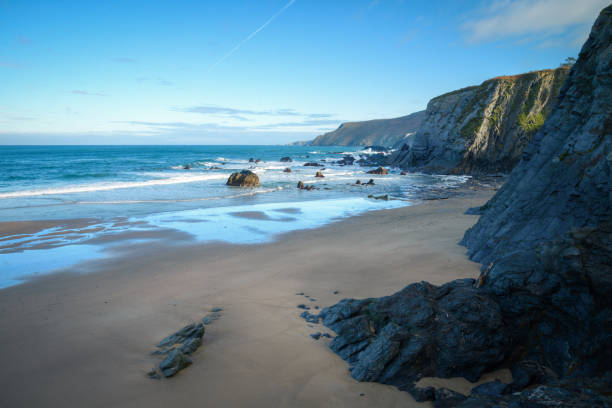 istock Deserted beach under the black slate cliffs in Loiba 1328289568