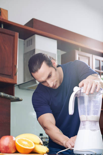 istock Fit Man Making Banana Smoothie 1328289799