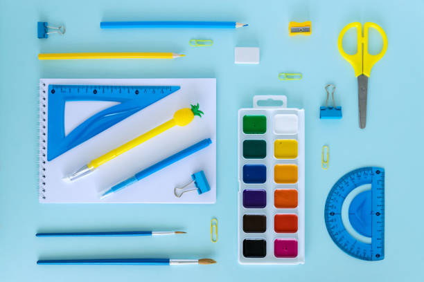 istock School supplies. Education concept. Everything for school and office. Pens, pencils, glue, brushes, paints and everything for study on a blue background. Back to school. Flatly. From above. 1328291105