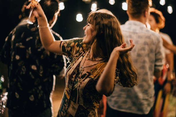 istock Woman dancing on party in back yard 1328291316