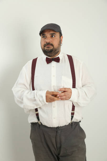 istock young man making gestures with his hands and face and drinking whiskey, 1328291348