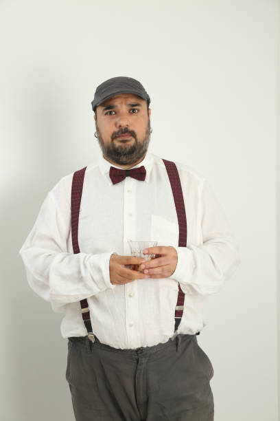 istock young man making gestures with his hands and face and drinking whiskey, 1328291361