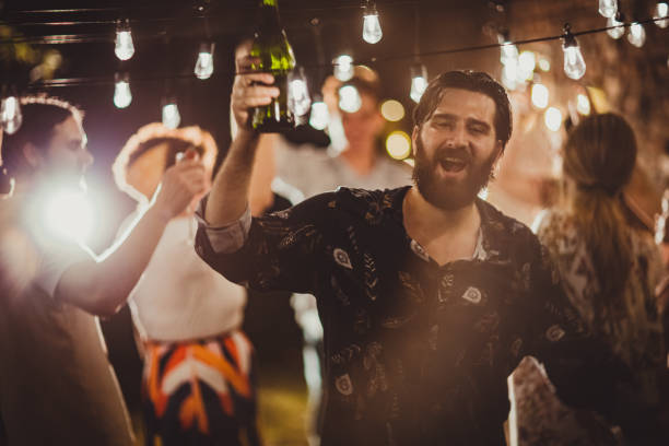 Man on on party in back yard Group of people, portrait of a man on party with friends in back yard outdoors. drunk stock pictures, royalty-free photos & images
